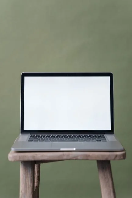 A minimalist desk setup featuring dual monitors, keyboard, mouse, and notebook for productivity.